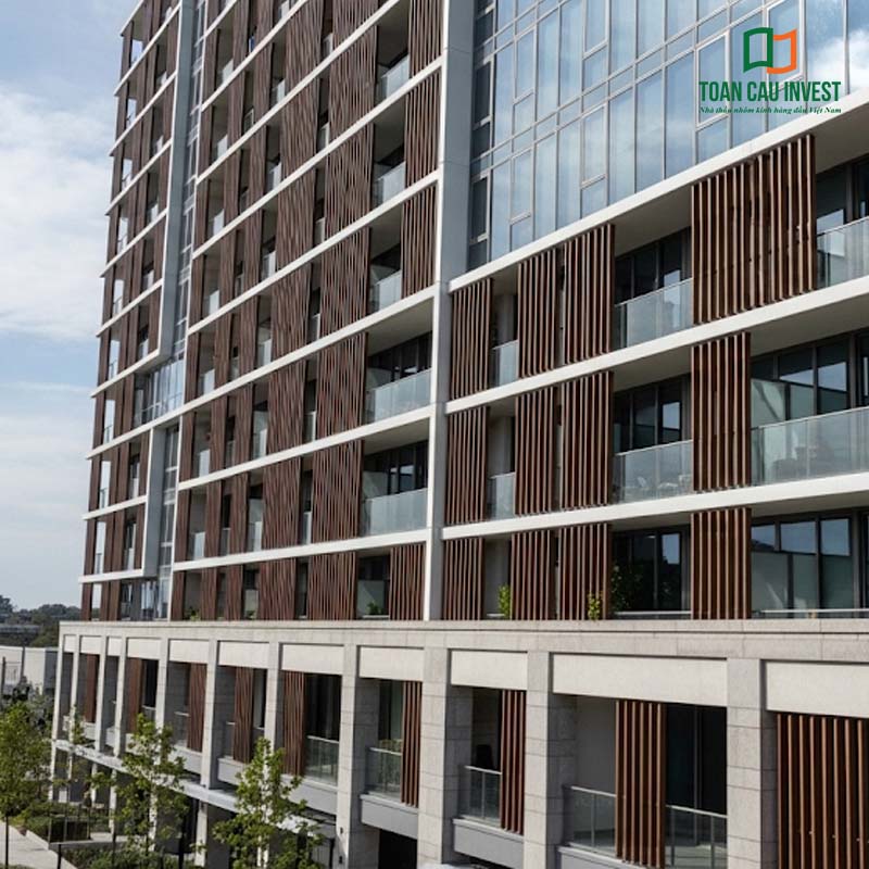 A high-rise residential building distinguished by a façade clad with wood-effect Vertical Sun Louvers, delivering a refined, modern, and luxurious appearance.