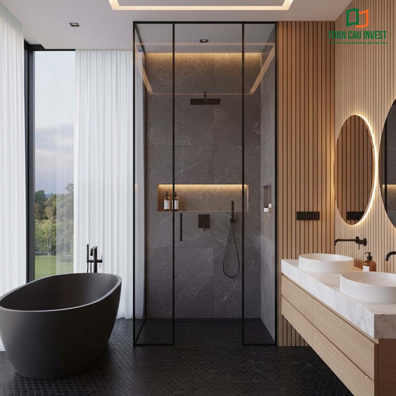Vách kính tắm slim khung đen kiểu chữ L, kết hợp nội thất sáng màu và ánh sáng tự nhiên tạo không gian thư giãn tinh tế.