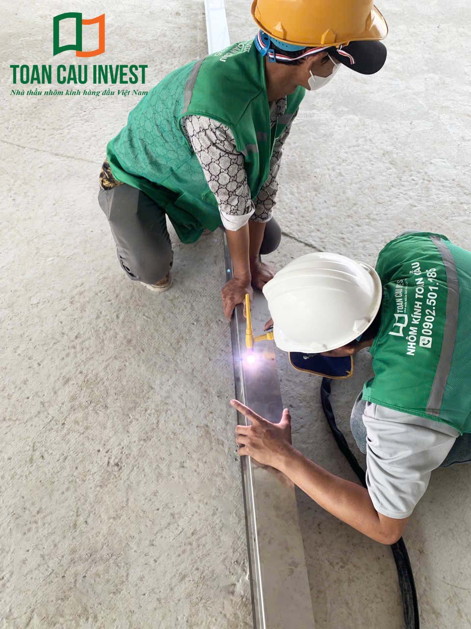 Hình ảnh nhôm kính thi công tại trung tâm đổi mới sáng tạo - đại học quốc gia Tp.HCM, kỹ sư đo đạc và kiểm tra các thanh nhôm trước khi đưa vào lắp đặt tại công trình.