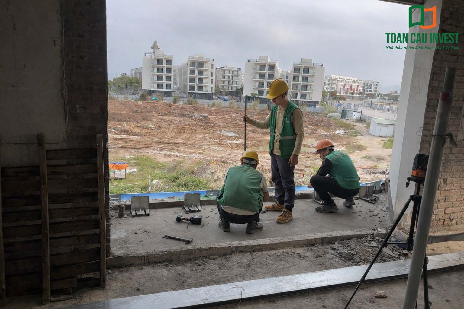 Hình ảnh nhôm kính thi công tại Sun Marina - Hạ Long, kỹ thuật viên căn chỉnh vị trí khung nhôm và hệ liên kết trước khi lắp kính.